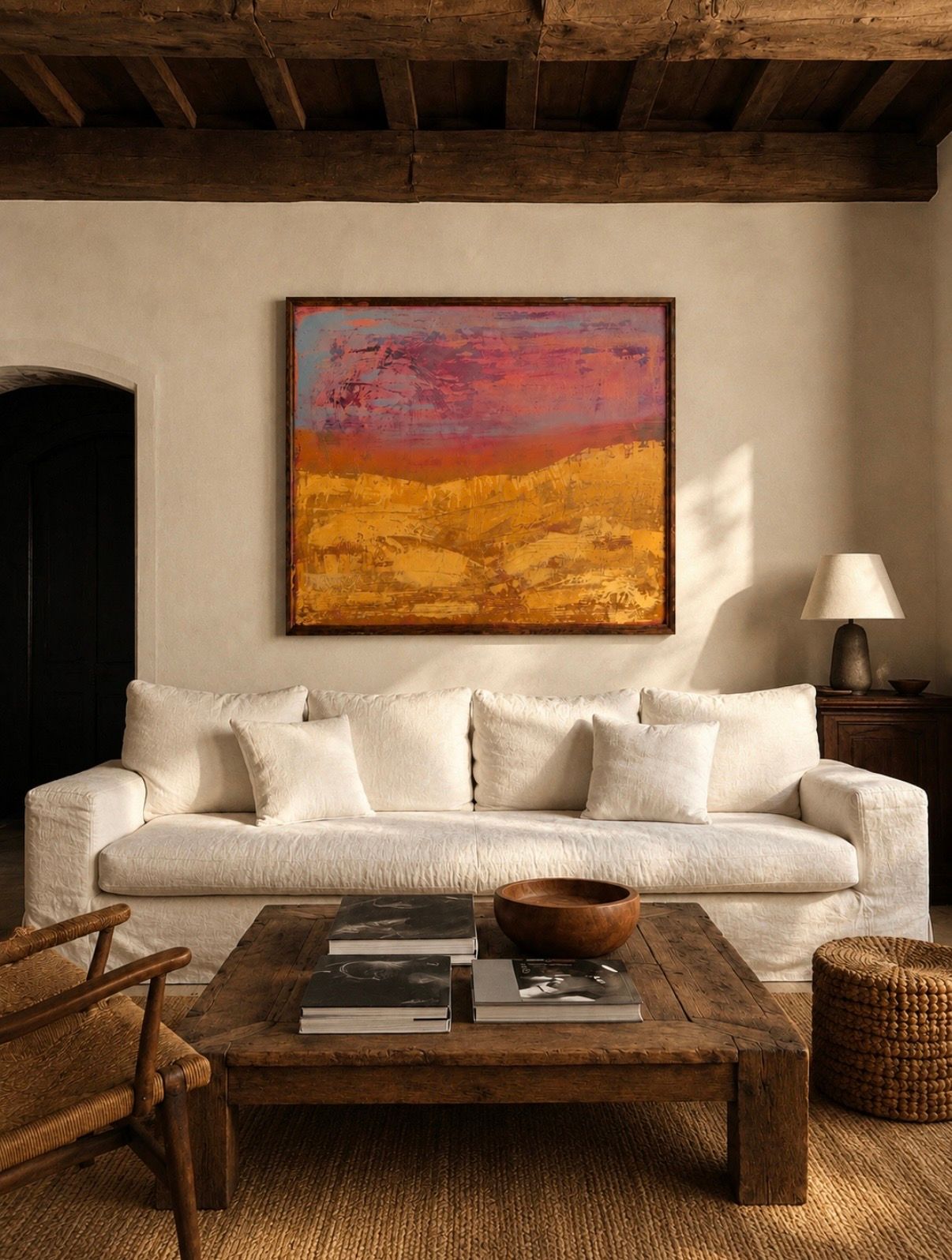 Large abstract painting of rolling hills in golds and pinks