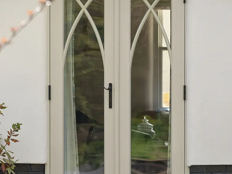 timber french doors with gothic bars