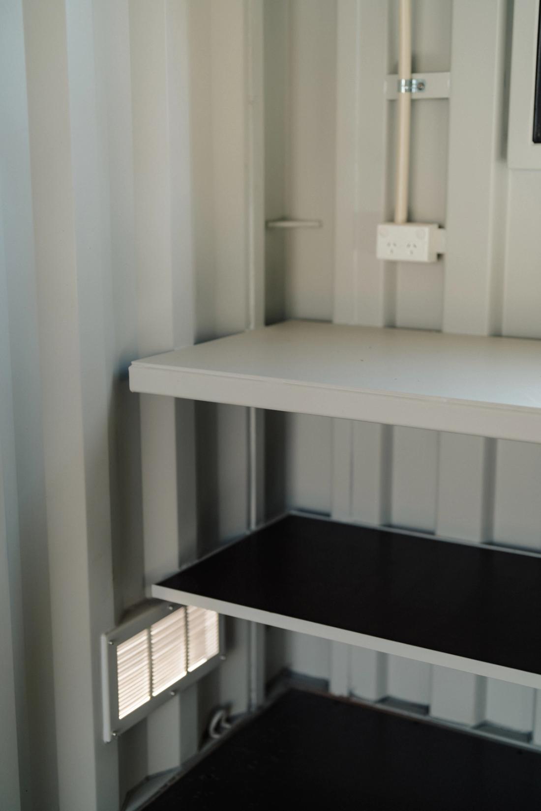 Steel workbench shelf with power points above