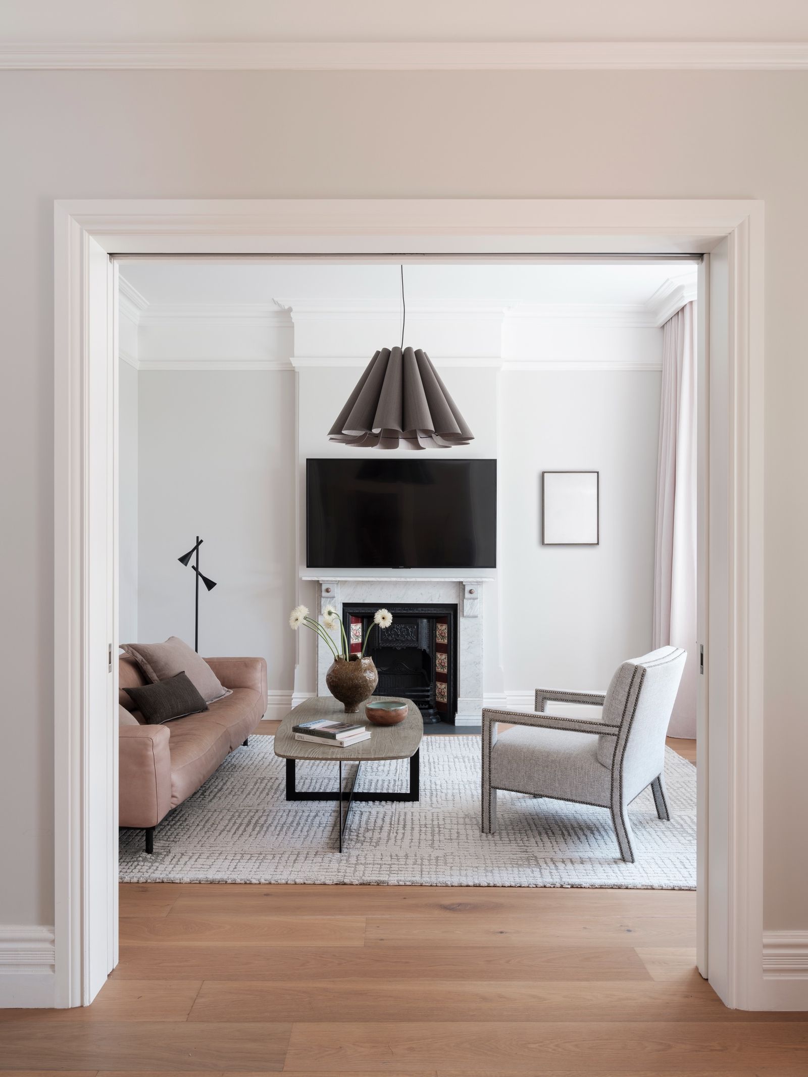 The formal living room, fireplace framed by the original opening