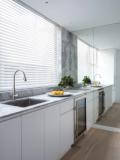 The marble kitchen bench running under custom floor-to-ceiling mirrors
