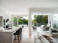 The new open-plan kitchen and living opening to the terrace