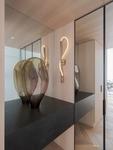 A glass sculpture against the mirrored entry joinery
