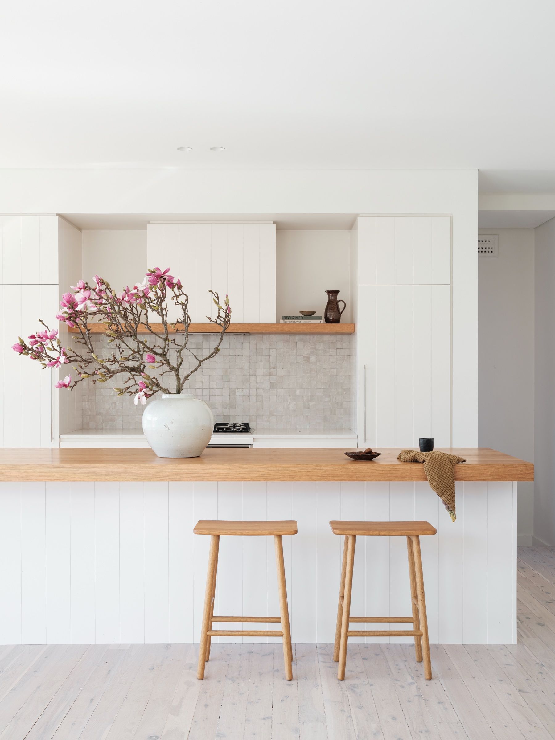 The oak-topped kitchen island with handcrafted tile splashback