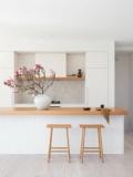 The oak-topped kitchen island with handcrafted tile splashback