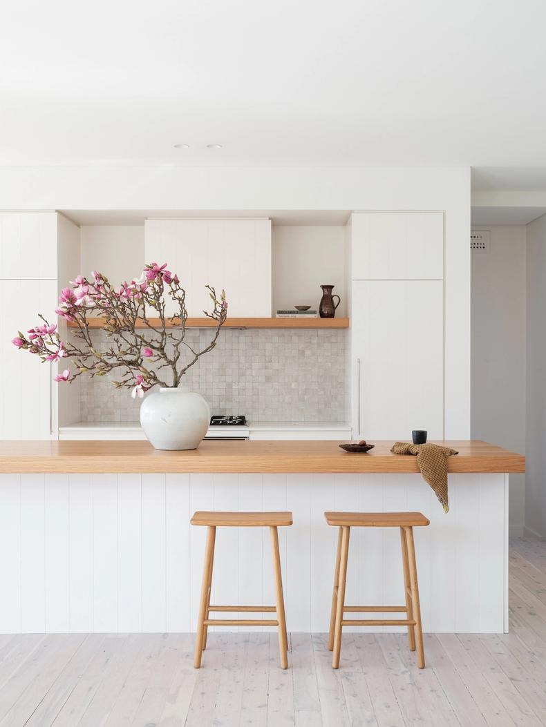 The oak-topped kitchen island with handcrafted tile splashback