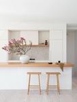 The oak-topped kitchen island with handcrafted tile splashback