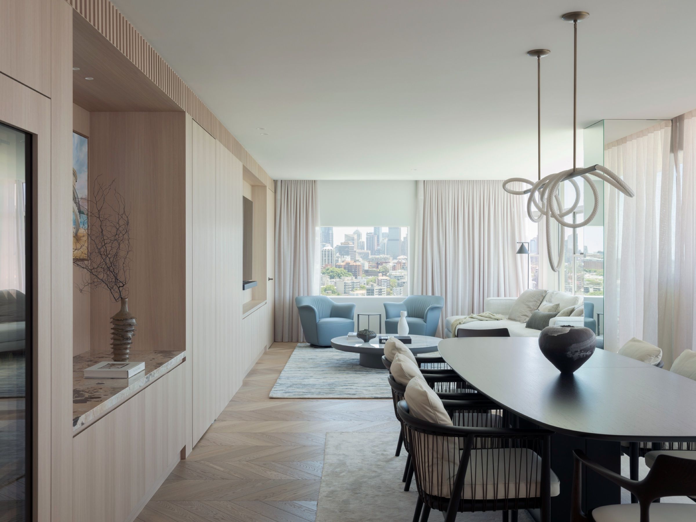 The open-plan living and dining, oriented to the city skyline
