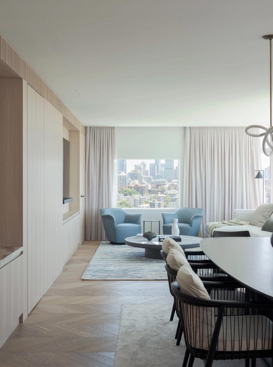 The open-plan living and dining, oriented to the city skyline
