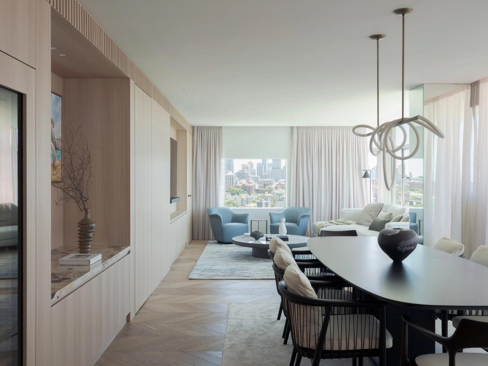 The open-plan living and dining, oriented to the city skyline