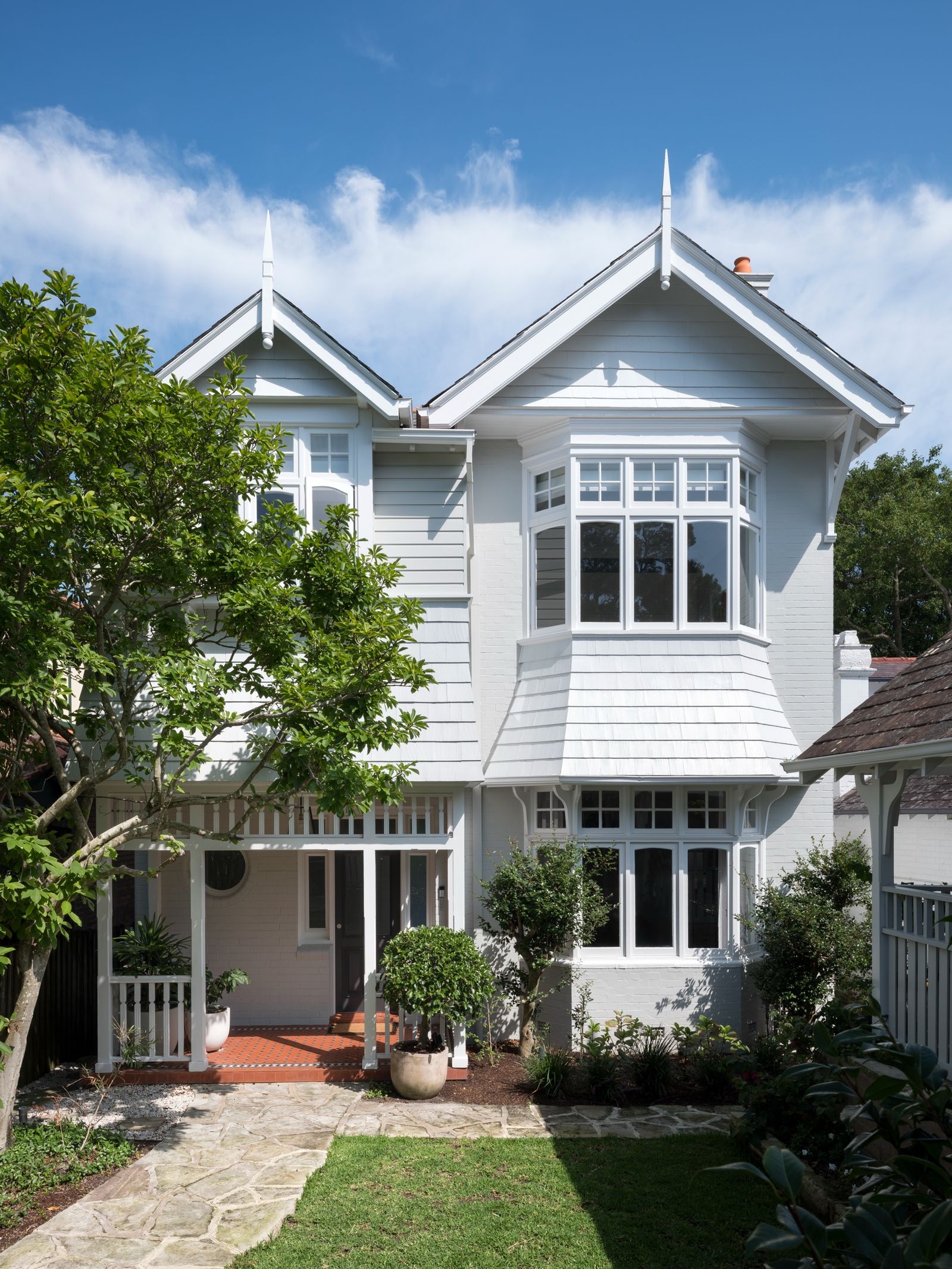 The restored weatherboard front elevation with its bay window