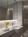 The marble bathroom vanity under full-height mirrored cabinets
