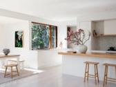 The dining table and benches beside the open corner window
