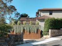 The street elevation: cedar-battened garage door under draping greenery