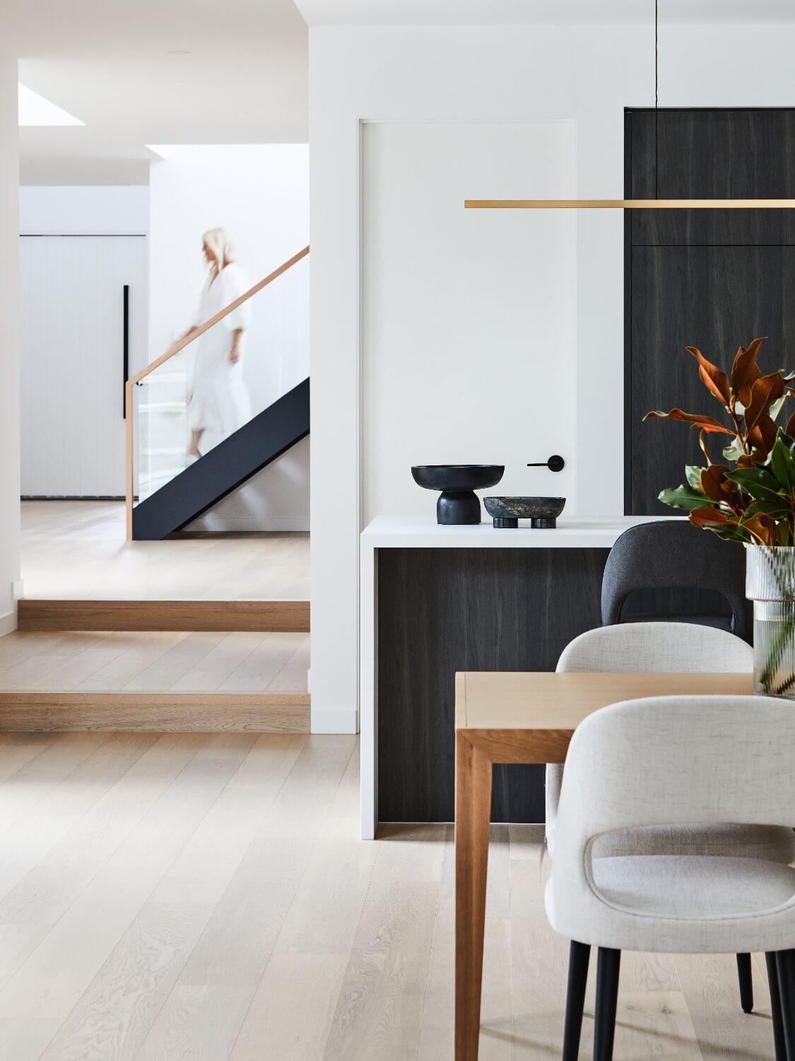 Timber Flooring Adds Warmth To Black And White Kitchen Stone And Cabinets