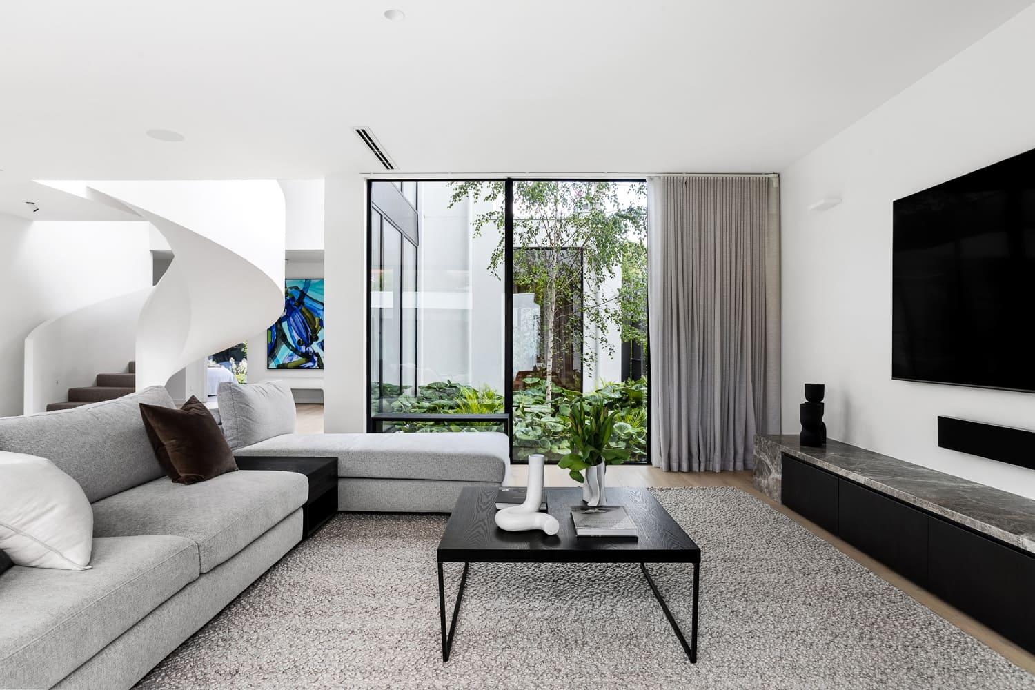 A contemporary living room featuring a spiral staircase.