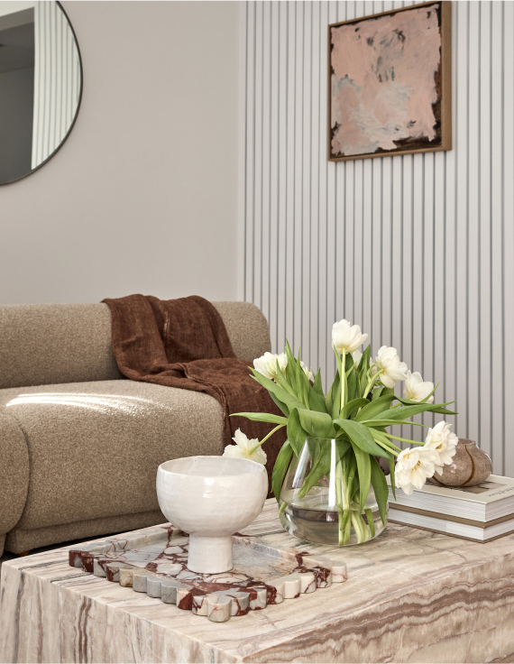 A formal lounge at the entrance with a mix of materials and neutral styling in a Bentleigh Residence