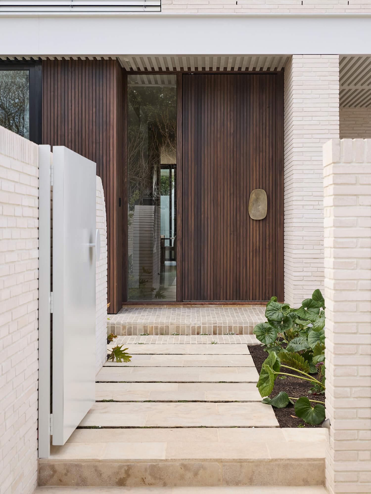 A contemporary custom facade designed by Thomas Archer with timber clad entry