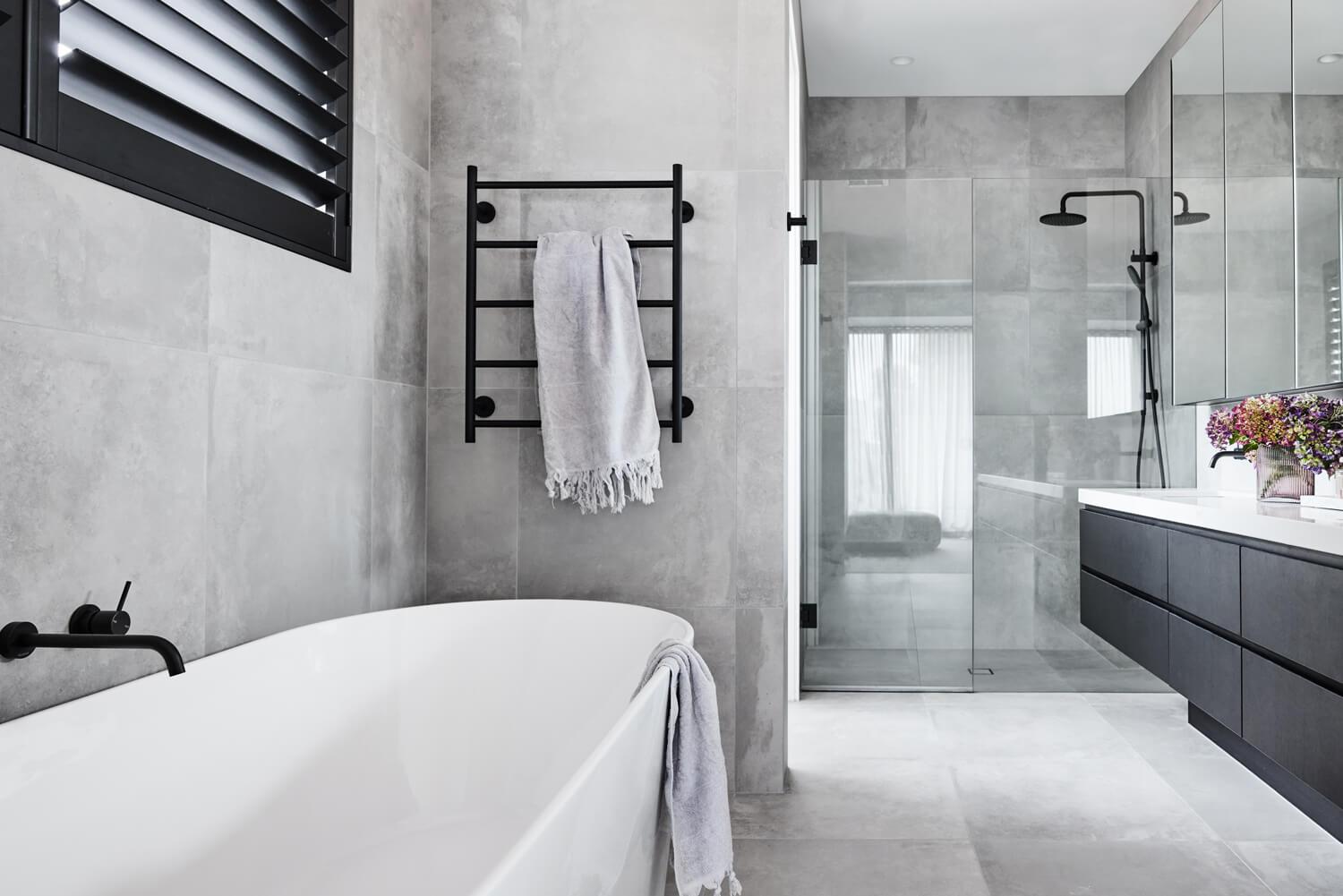 Full Grey Tiling Ties Together Black Fittings And White Tub And Benchtop