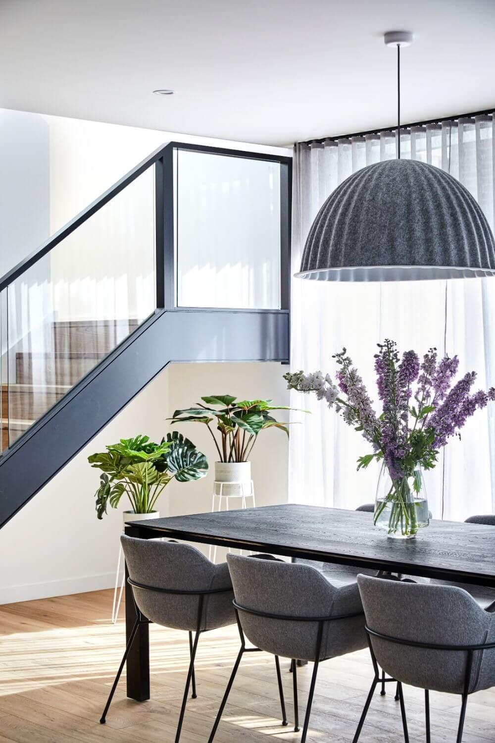 Large Windows And Glass Balustrades Enhance Light Feeling In Dining Room