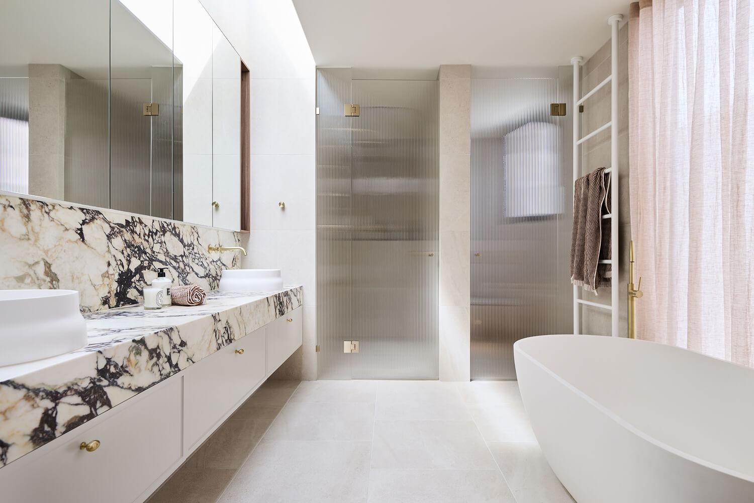 Thomas Archer custom designed ensuite with freestanding bathtub and statement calacatta viola benchtop