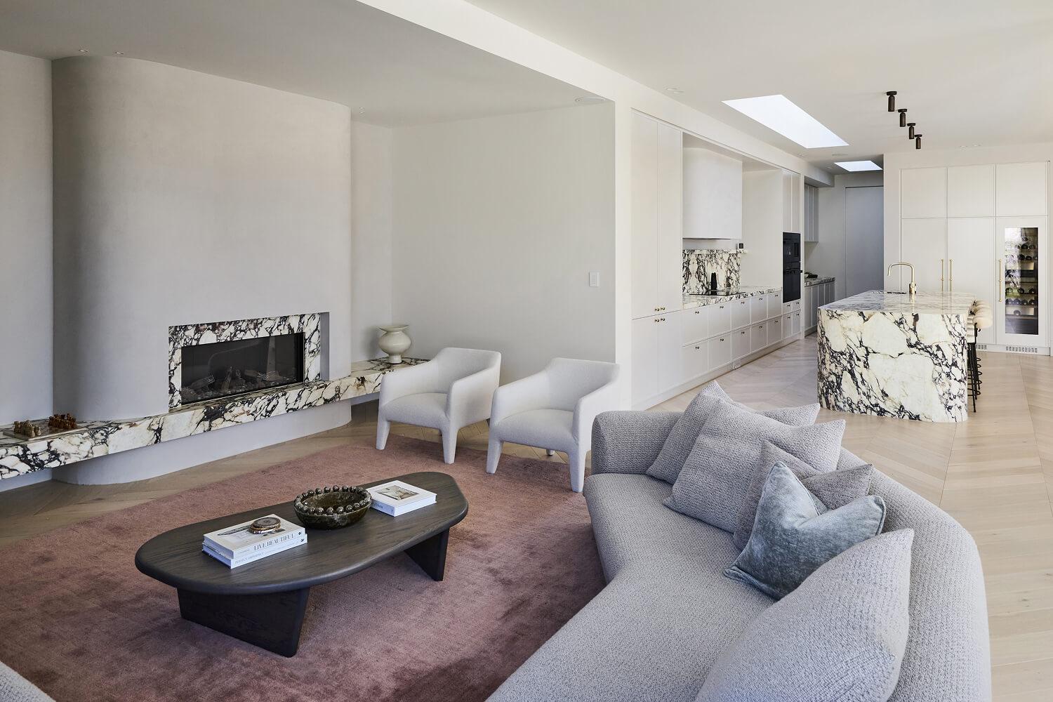 An architecturally designed open living by Thomas Archer with statement calacatta viola stone