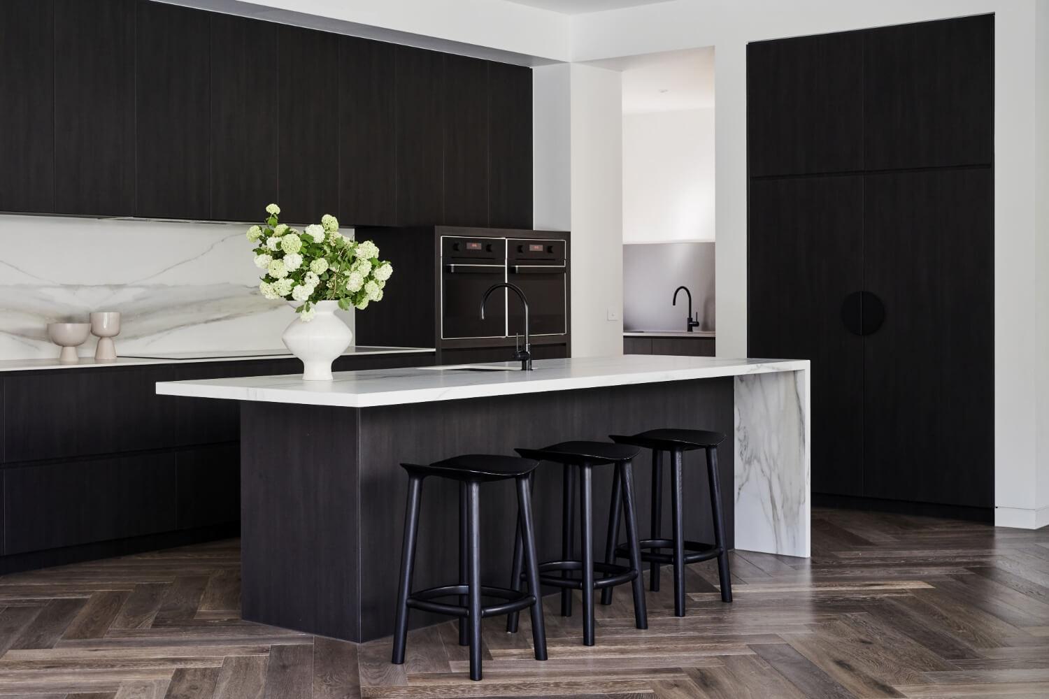 Timeless Contemporary Kitchen With High Contrast Cabinetry And Stone