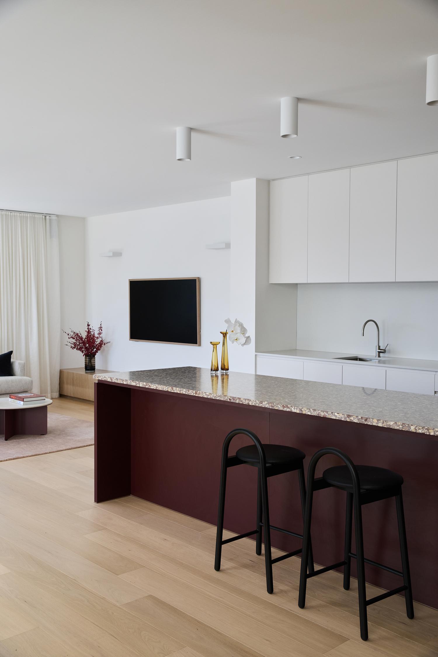 Thomas Archer–designed and built modern kitchen and living area featuring luxurious terrazzo benchtops, refined cabinetry.