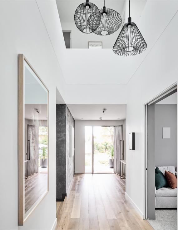 A contemporary entrance way with timber floors and large void