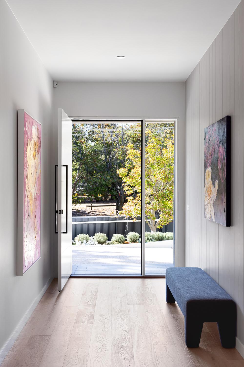 Spacious hallway overlooking lush green landscape