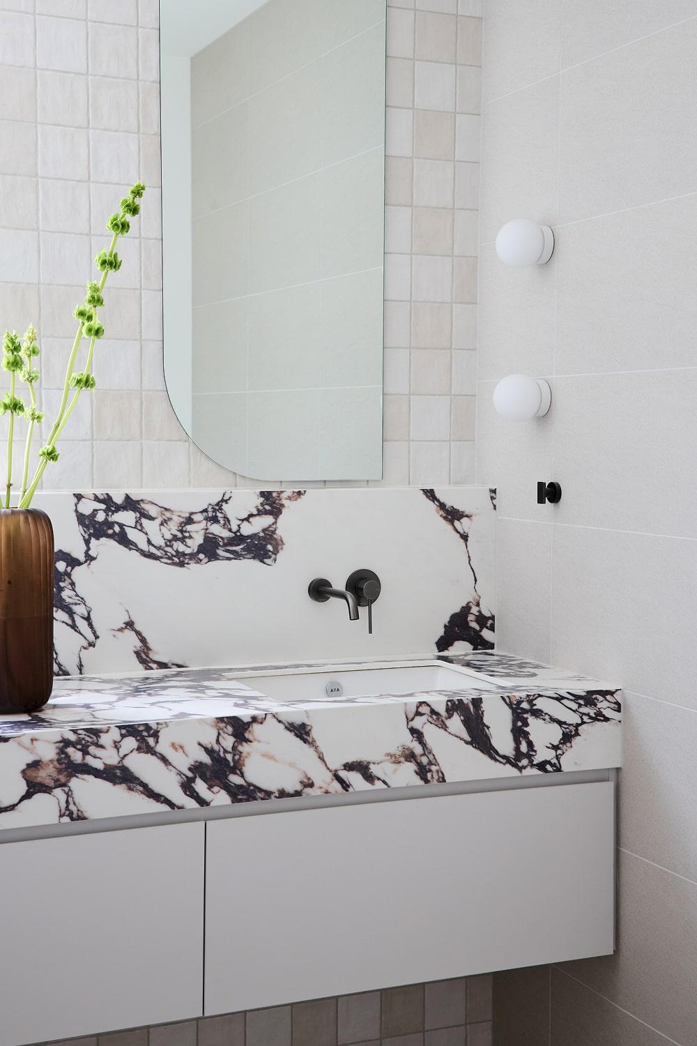 Thomas Archer custom designed poweder room with calacatta viola stone