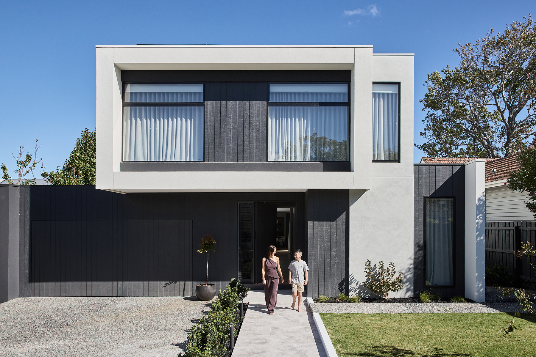A contemporary, architecturally designed facade by Thomas Archer with landscaping in the foreground