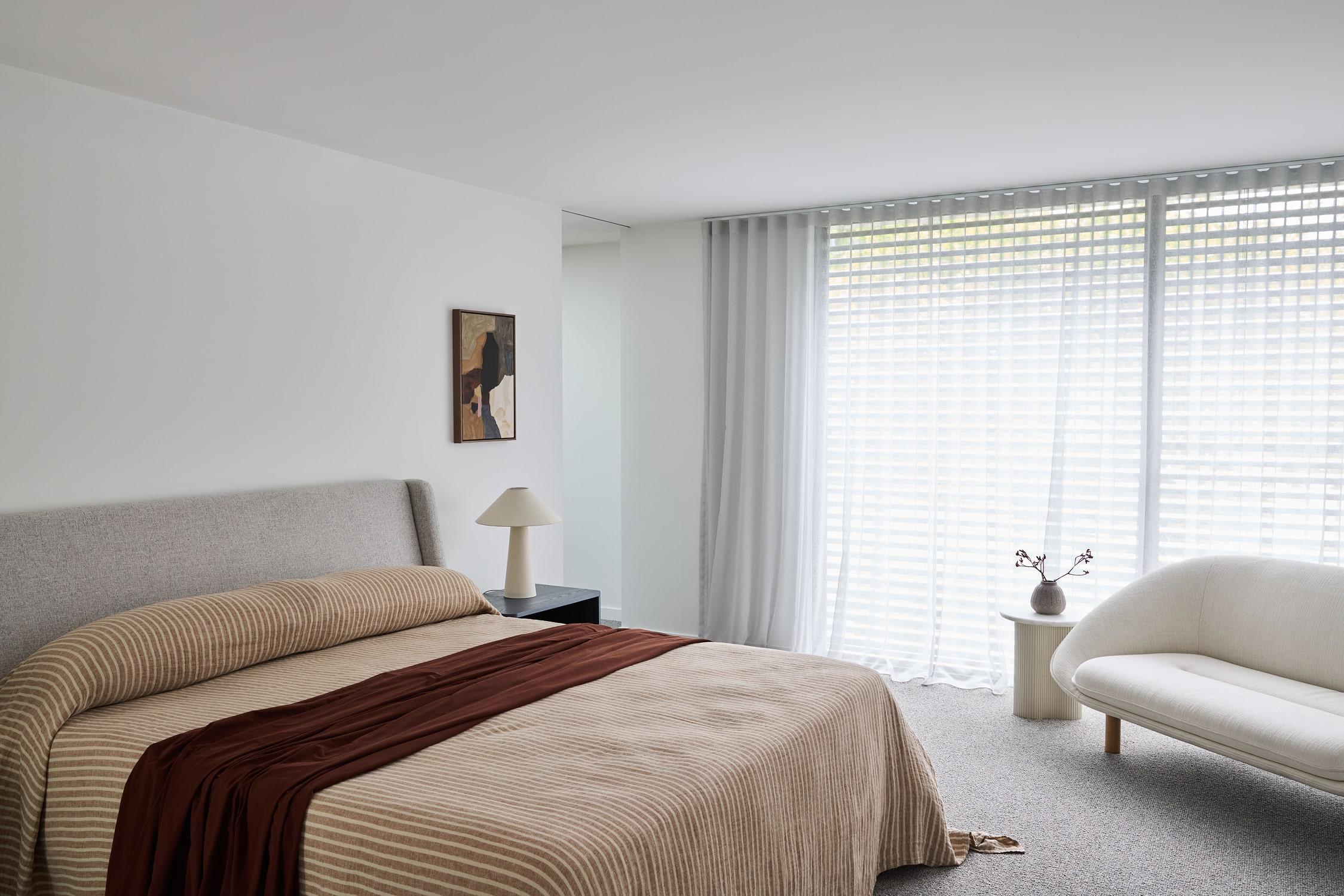 A minimalist bedroom within a Thomas Archer designed primary suite