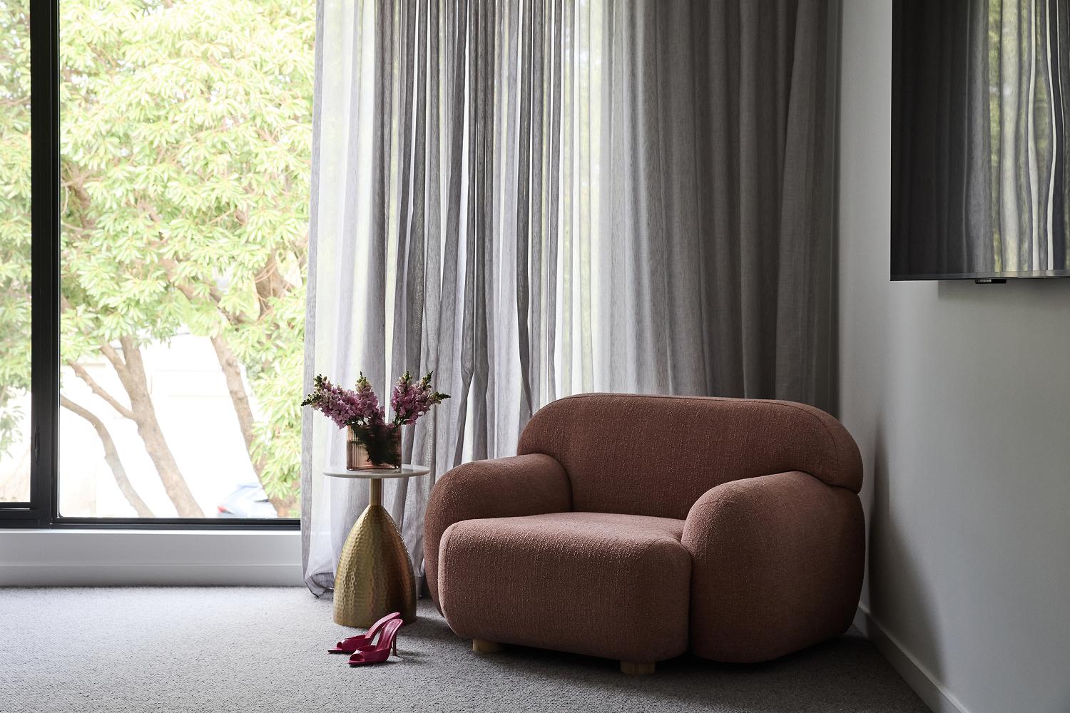 Master bedroom styled corner with floor to ceiling windows, designed and built by Thomas Archer.
