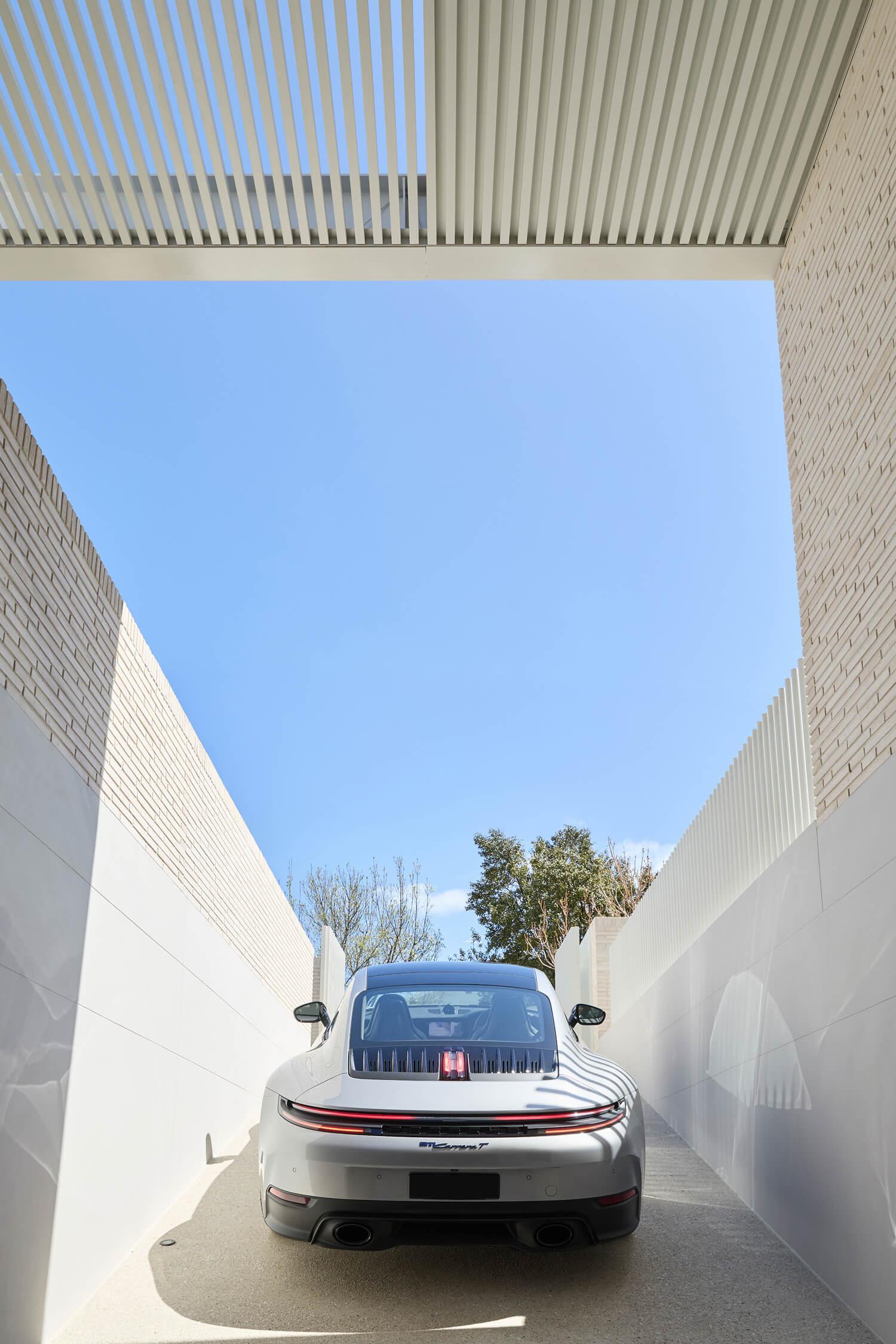 A car pulling out from the integrated basement garage of a custom Thomas Archer home in Melbourne.