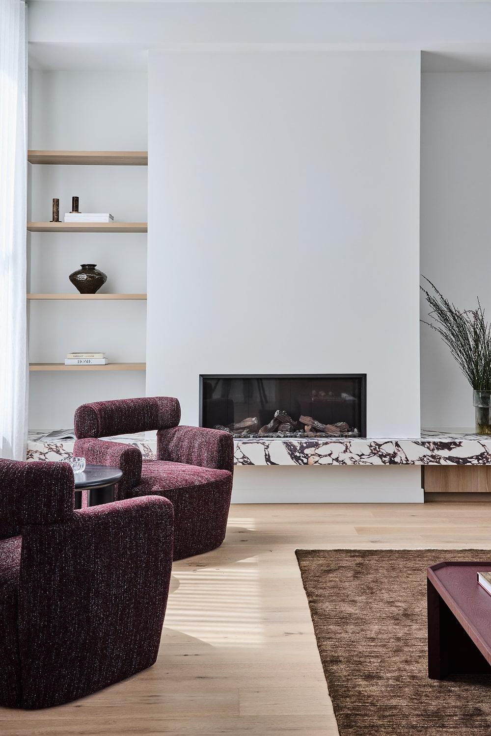 Thomas Archer designed living room with feature fire placed with Calacatta Viola stone joinery