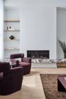 Thomas Archer designed living room with feature fire placed with Calacatta Viola stone joinery