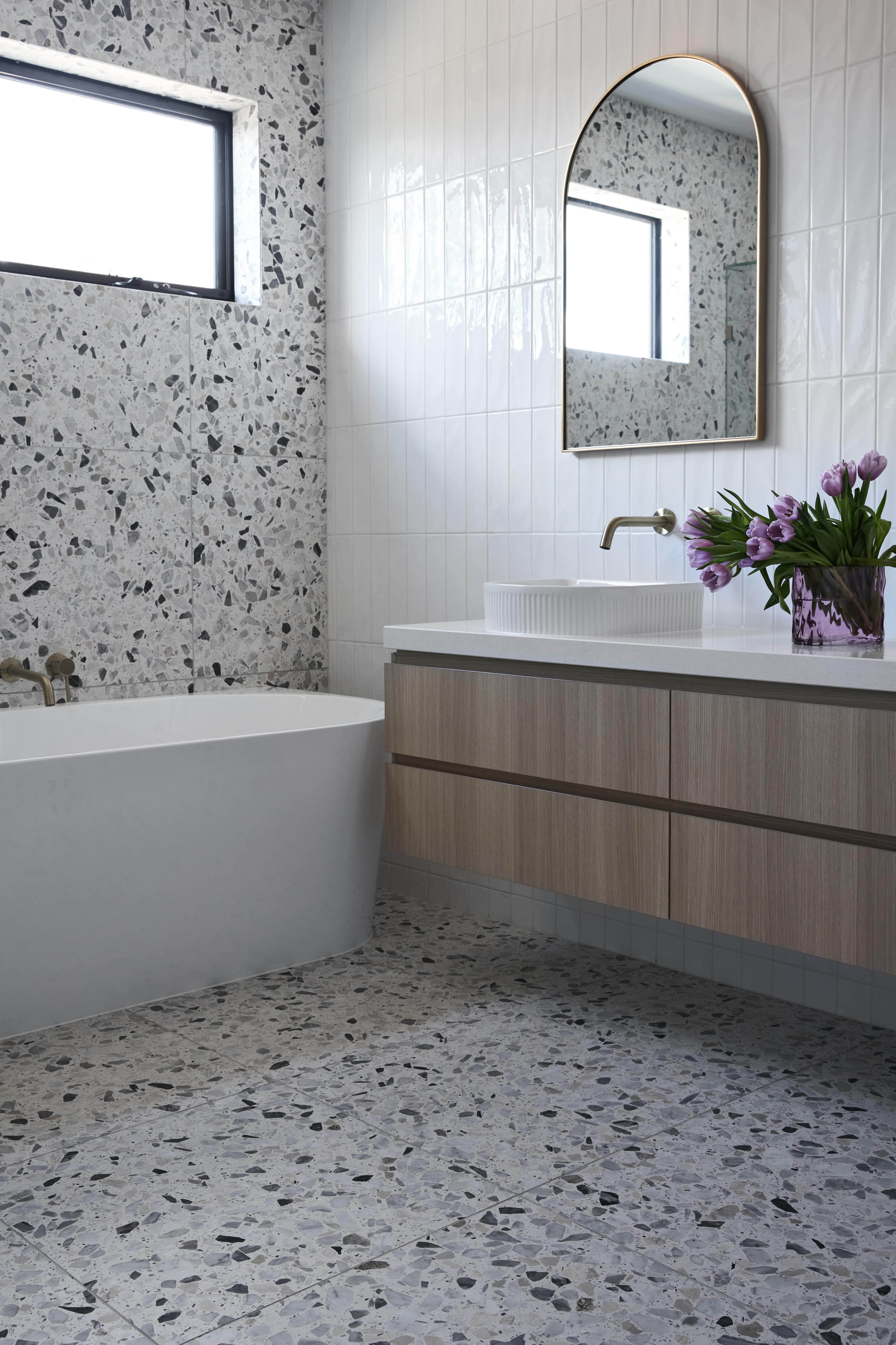 Terrazzo clad bathroom with feature mosaic tiles designed and built by Thomas Archer