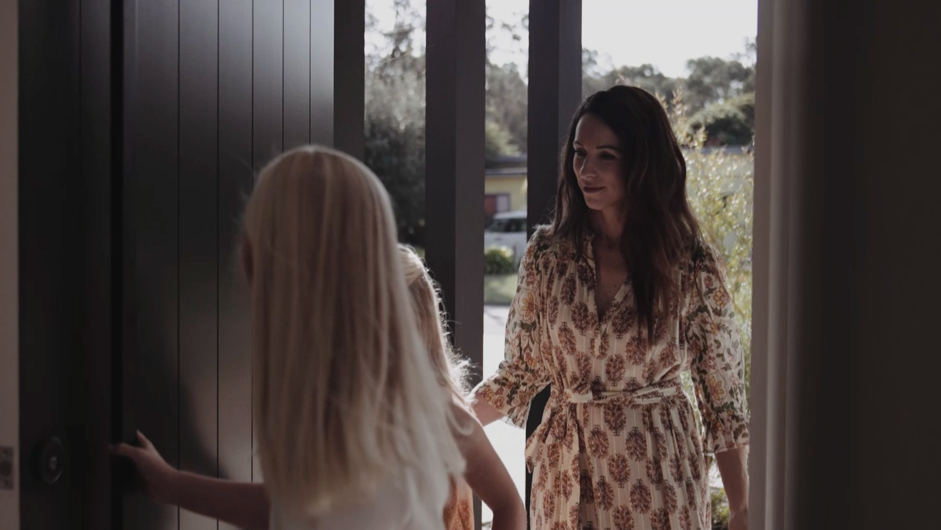 Two women entering a front door