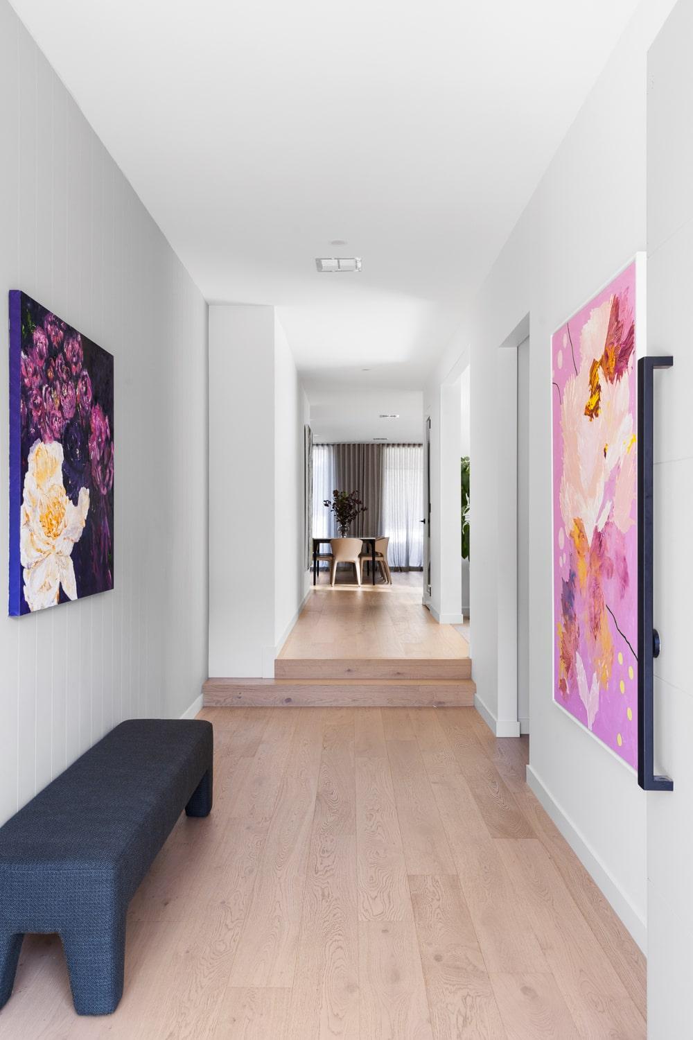 Spacious hallway with bright artwork