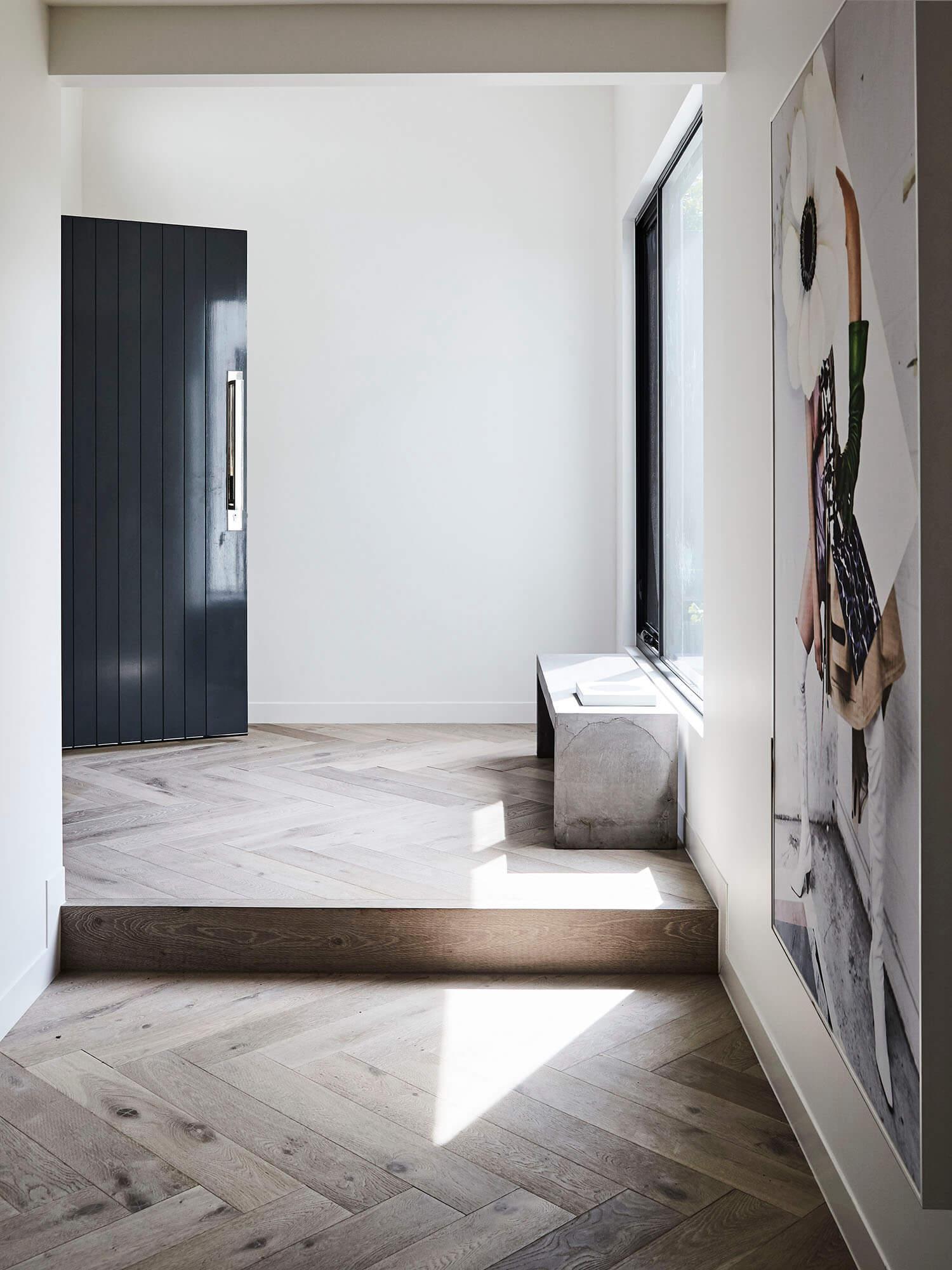 Front entranceway of modern residential home with herringbone timber flooring