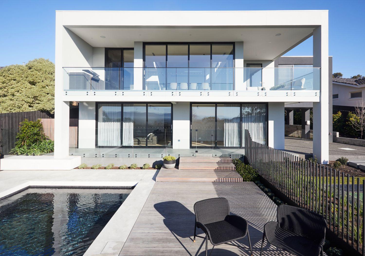 Balcony With Glass Balustrade Overlooking Pool Area