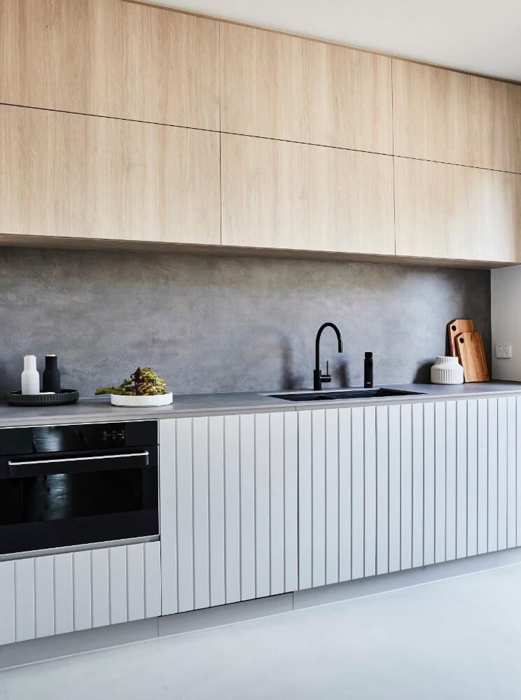 Minimalist Kitchenette Design With Slat Detailing On Cabinetry 