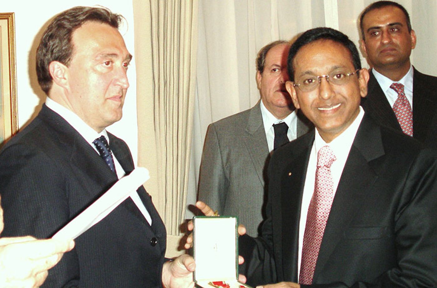 Being conferred knighthood by the Italian Minister