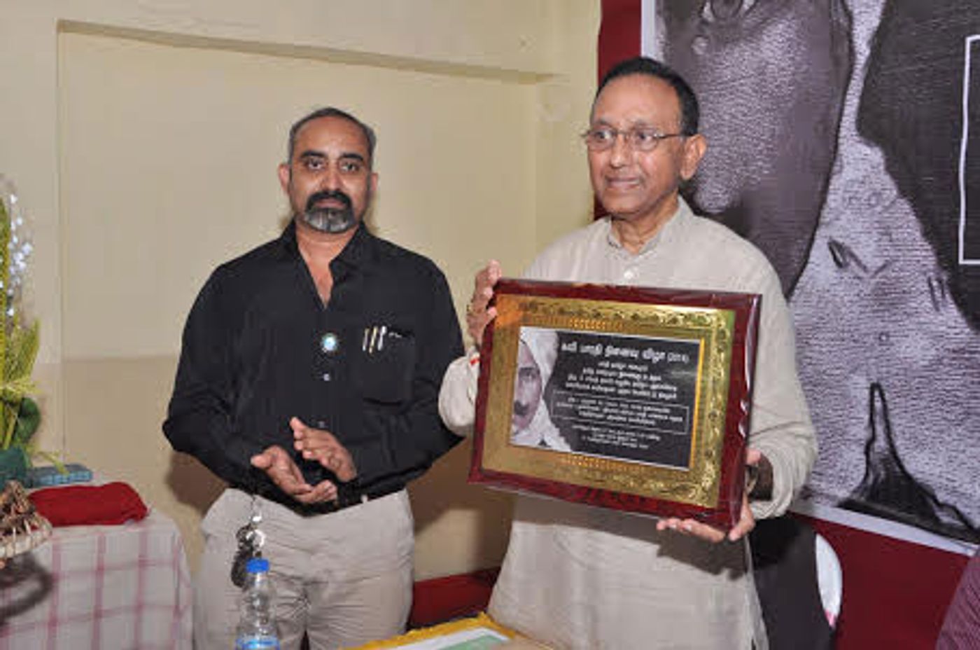 Kumar felicitated with a plaque on a Tamil poem book release