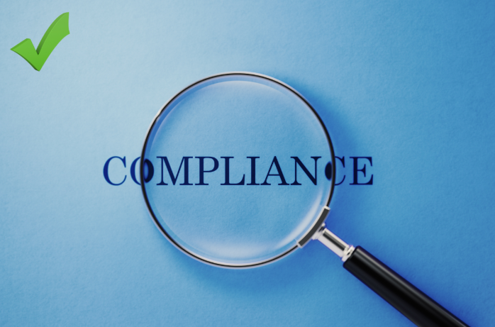 Word compliance on a blue background under a magnifying glass. 