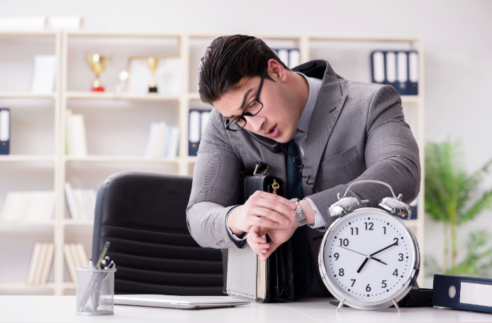A man looking at his watch in a hurry, tracking the 24-hour WhatsApp messaging window.