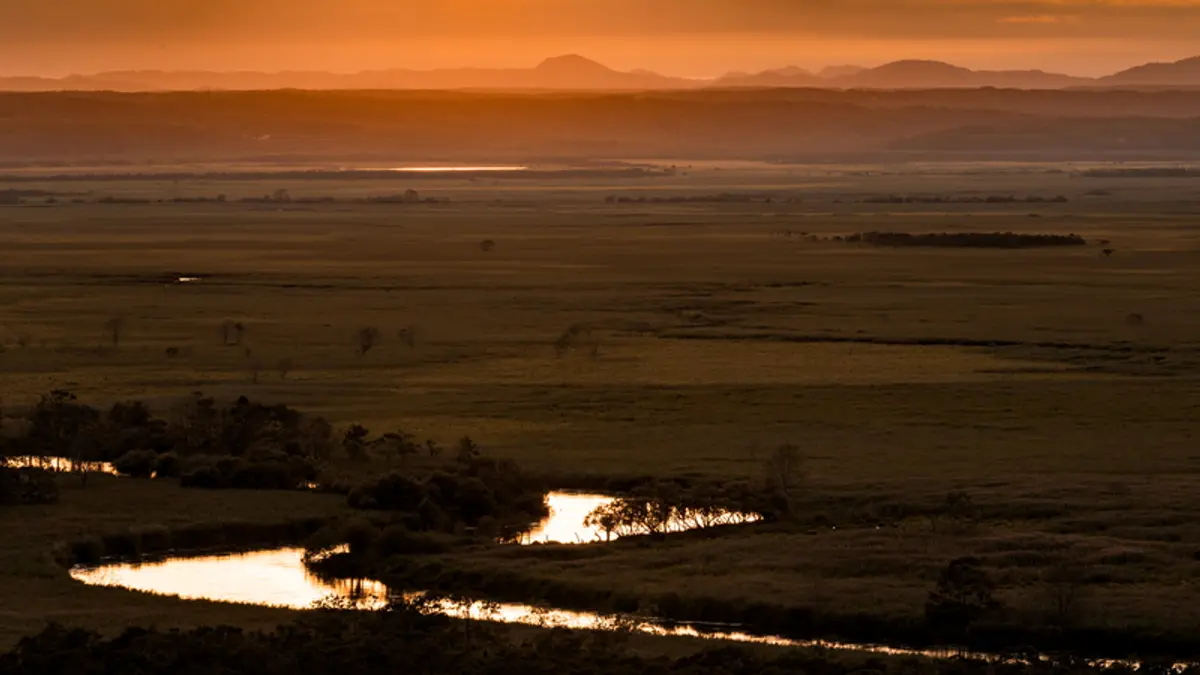 Sunset over the Kushiro Wetlands and its winding river in eastern Hokkaido, Japan