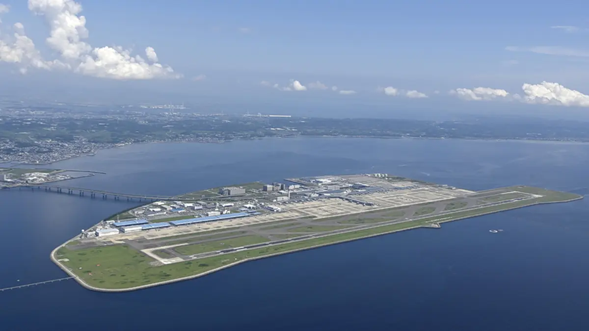 Aerial view of Chubu Centrair International Airport on an island in Ise Bay, with runways, terminal buildings and the bridge to the mainland