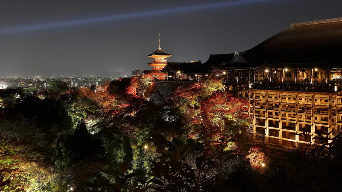 Kiyomizu-dera temple in Kyoto illuminated above the city at dusk